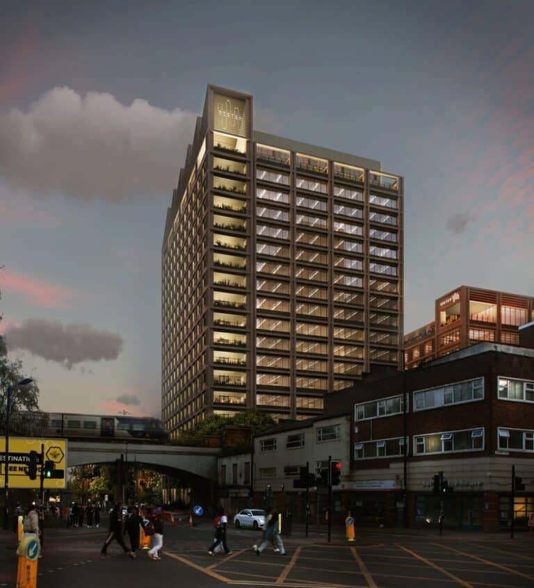 Modern high-rise commercial building at dusk in Manchester’s Sister District, featuring illuminated floors and green terraces, with pedestrians crossing below — a key example of urban expansion integrating architecture and public life.