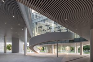 Spiral ramp and glass facade of the Taichung Art Museum and Public Library Complex, showcasing cultural integration architecture with semi-transparent materials and barrier-free design.