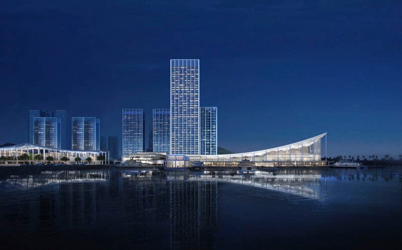 Aerial view of Jiuzhou Bay Port 2026 at dusk, showing the illuminated transit hub and mixed-use complex on the Zhuhai waterfront.
