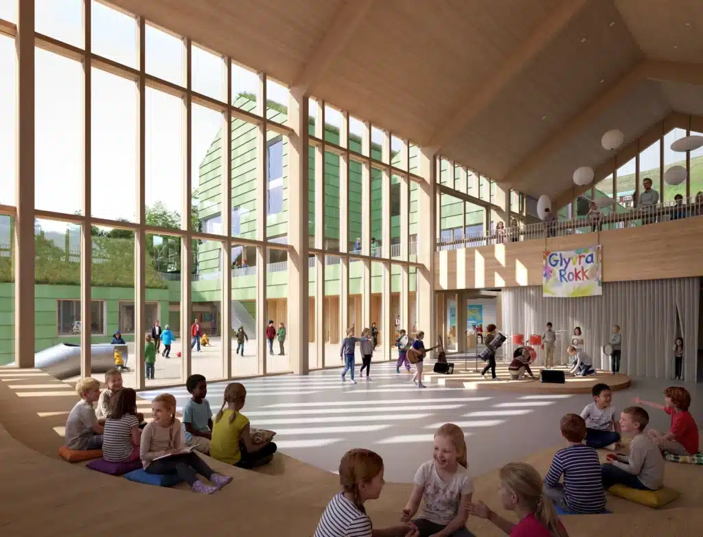 Interior of a classroom at Glyvra School, featuring large windows with views of the fjord and natural wood finishes. Glyvra School.