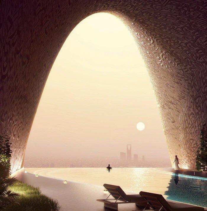 Infinity pool framed by a monumental arched opening with Arabic calligraphy patterns, overlooking the Riyadh skyline at sunset.