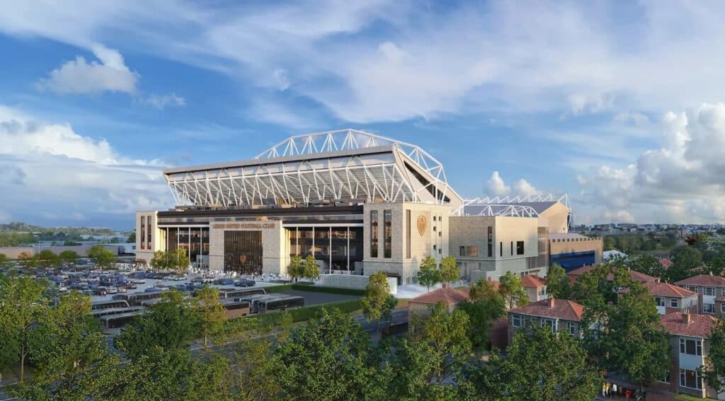 Elland Road expansion rendering showing the stadium&rsquo;s new facade and roof structure against a blue sky, with surrounding residential area and parking visible.