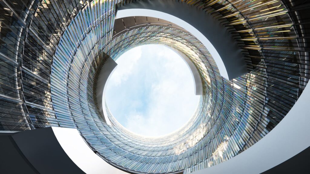 Interior view of the Beijing Art Museum&rsquo;s central atrium, showcasing its spiraling glass and steel structure with a circular skylight framing the sky.