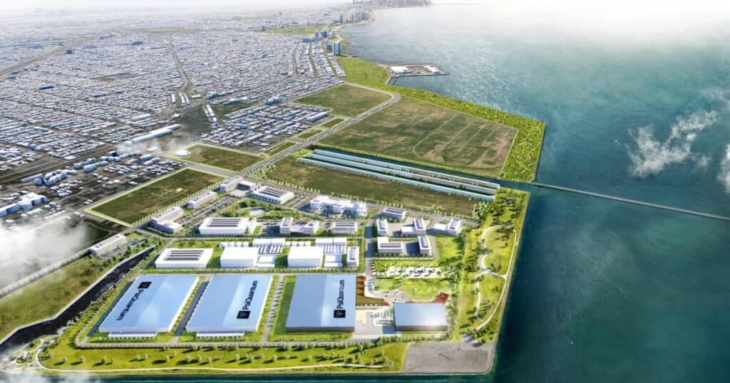 رسم تخطيطي جوي لحرم Illinois Quantum & Microelectronics Park في جنوب شيكاغو، يُظهر دمجه مع الساحل، ومجموعات المباني البحثية منخفضة الارتفاع، ومرافق PsiQuantum الرئيسية بجانب بحيرة ميشيغان.