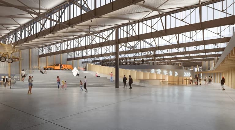 رسم تخطيطي للداخلية يُظهر قاعة العرض الرئيسية في متحف ميشلان فاكتوري في  فيران، مع سقف من عوارض فولاذية بطول 30 مترًا، وضوء طبيعي من نوافذ السقف المسنن، ووحدات عرض مغطاة بالخشب متكاملة في الهيكل الصناعي.