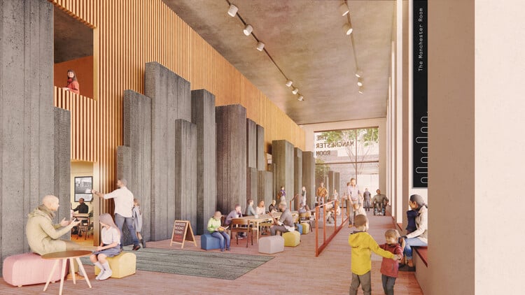 مشهد داخلي لمساحة جماعية مرنة متعددة المستويات في مشروع Plot C بمانشستر، تضم ألواح خشبية وأعمدة خرسانية، وأشخاص يشاركون في أنشطة عمل اجتماعية غير رسمية.