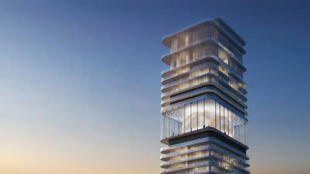 Inuara Tower at twilight, showcasing its luminous ovoid Sky Lounge encased in glass, with cantilevered balconies and tiered massing against a gradient sky.