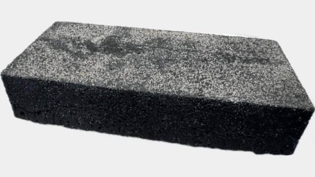 Composite image showing stacked concrete blocks, a lab scale arched sample, and sustainability icons  visual summary of carbon negative building materials research.