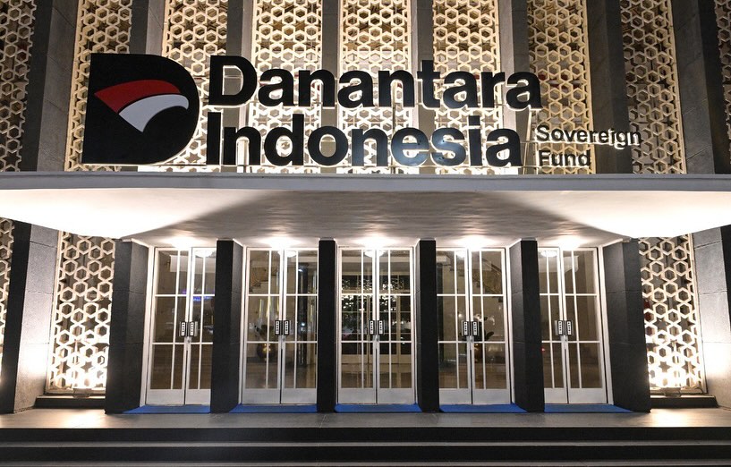 Exterior of Danantara Indonesia Sovereign Fund headquarters, showcasing modern architectural design with geometric facade patterns and illuminated signage.