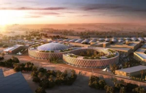 A digital rendering of a futuristic, circular data center complex in Riyadh, Saudi Arabia, featuring a large glass dome and desert landscaping at sunset.
