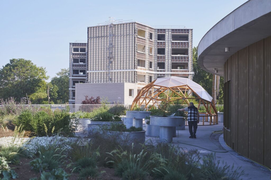 Rooftop garden at L'Alliance school with a wooden geodesic dome structure and circular planters.