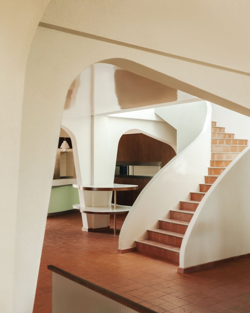 Architectural view of a staircase and arched openings at Le Belv&eacute;d&egrave;re restaurant designed by Rudy Gu&eacute;naire.