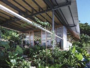 Exterior view of the Okinawa architectural office featuring a double-layered structure with insect mesh and folding vinyl panels.