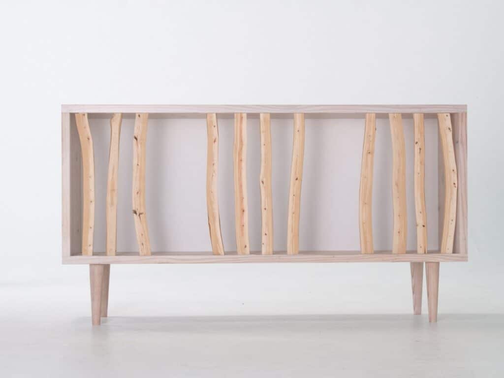 Minimalist view of the Hayashi Cabinet with cypress branches spaced unevenly across a wooden frame.