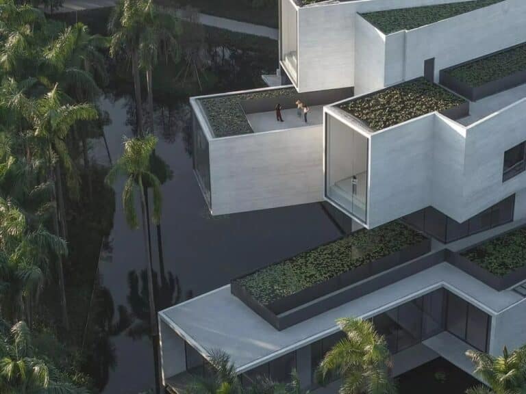 Aerial close-up of the Pearl River Delta Wetland Museum featuring stacked concrete tubes and rooftop water gardens.