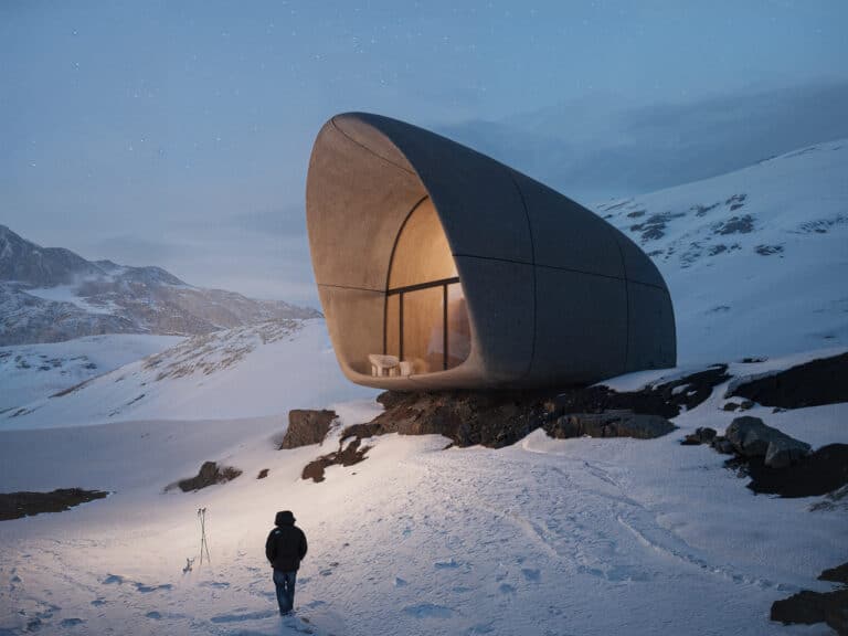 Exterior view of AltiHut mountain shelter on Mount Kazbek at twilight with a climber walking on snow.