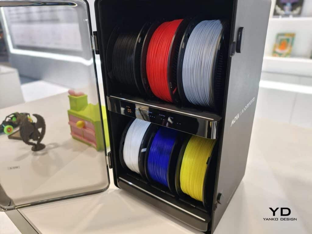 Open RFD-6 filament dry box by AtomForm containing six colorful filament spools including red, blue, and yellow.