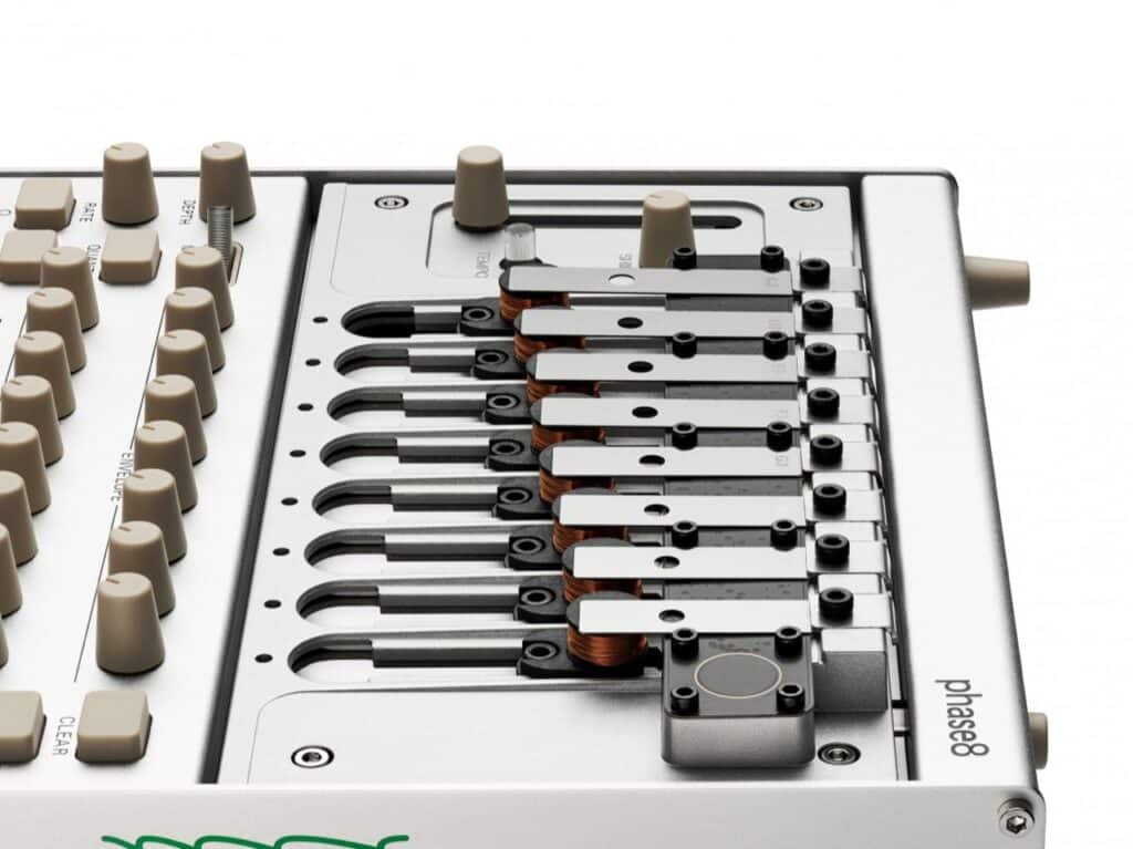 Detailed close-up view of the electromagnetic hammers and steel resonator bars of the Korg Phase8, illustrating the mechanical acoustic synthesis system.