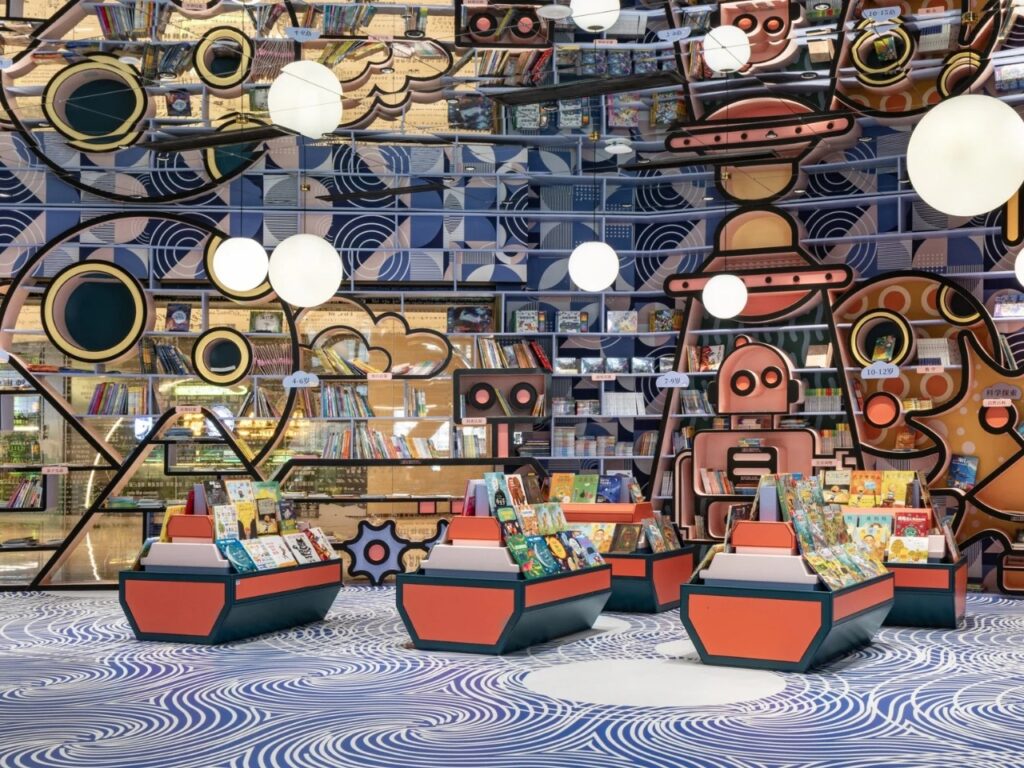 Huai&rsquo;an Zhongshuge children's area with colorful illustrations of rockets, robots, and space themes on bookshelves and floor.