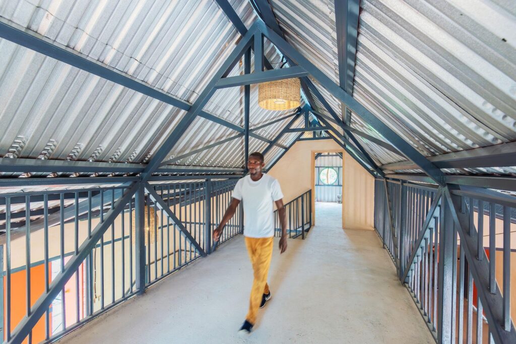The upper floor of the community center inspired by the traditional Haitian Galata, showing the mezzanine and ventilated steel roof.