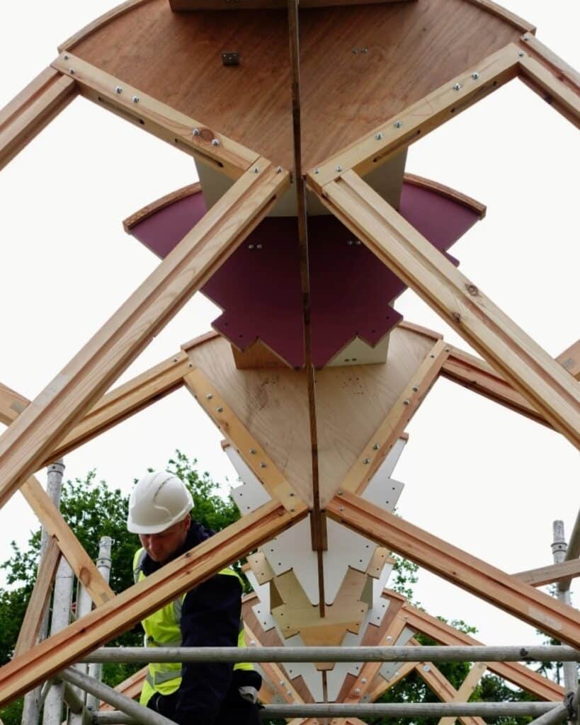 Vertical view of the central spine and modular nodes of the Arkhive pavilion during construction.