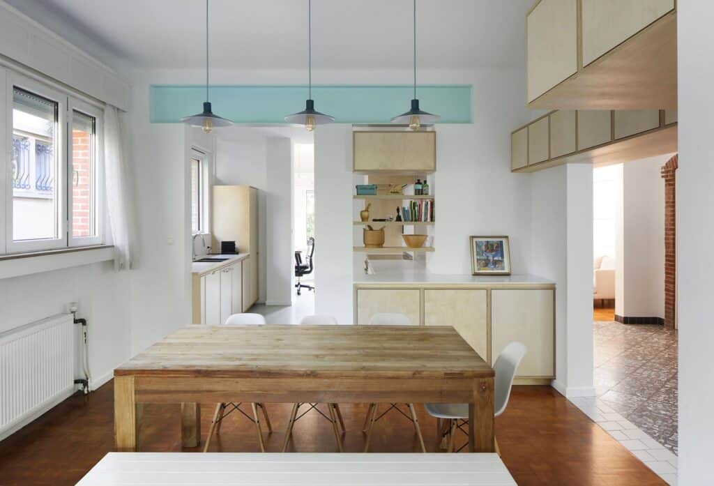 Integrated custom cabinetry and shelving acting as a bridge between the kitchen and dining room.