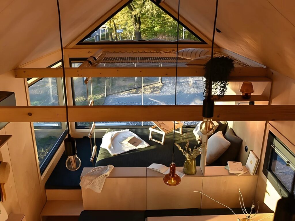 High-angle view of the Net-Mezzanine in Julia home, showing a suspended net for relaxation over the main living area.