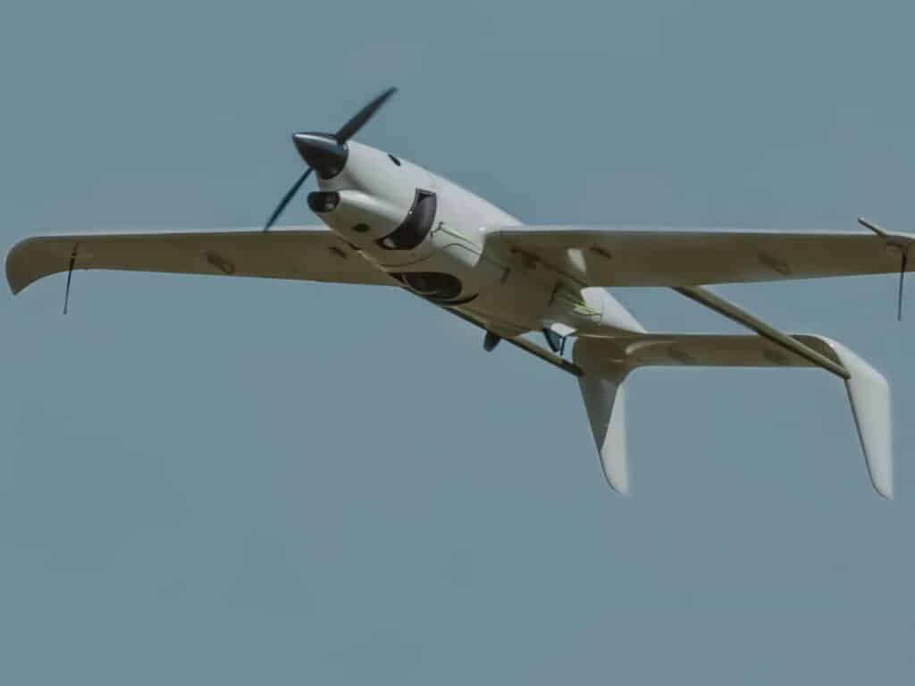 Low-angle shot of the Raybird hydrogen drone soaring in a clear blue sky during a flight test.