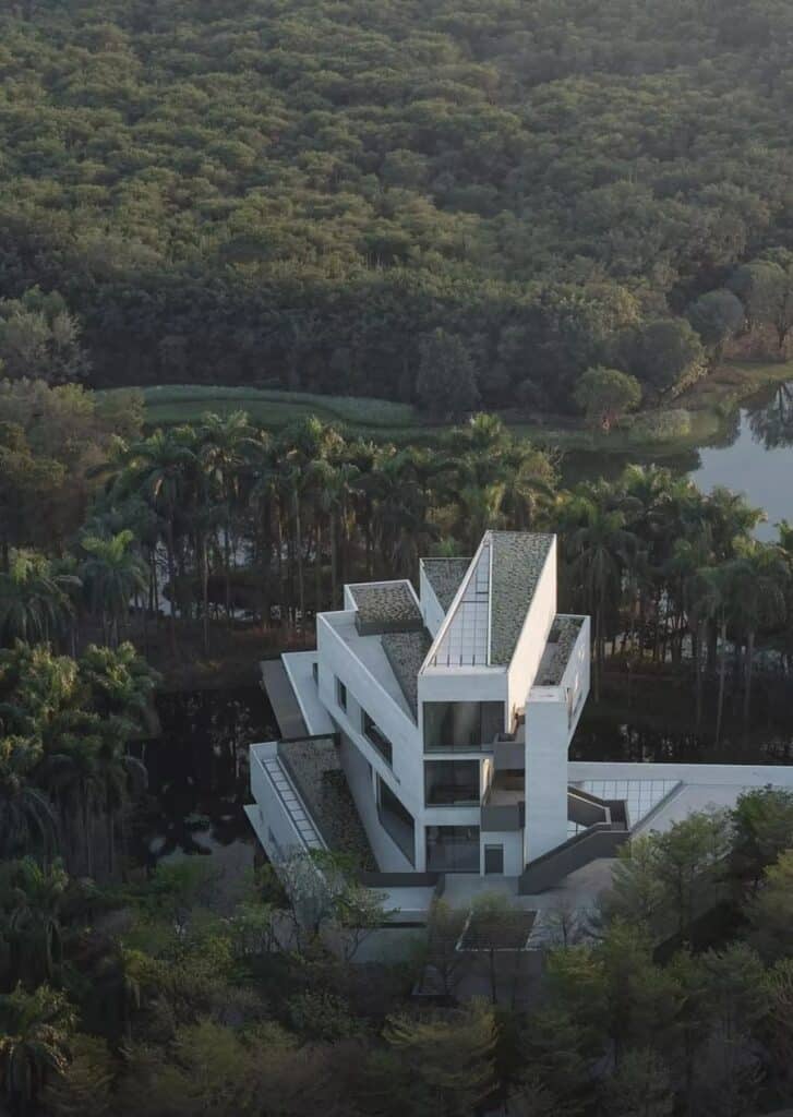 High-angle aerial view of the Wetland Museum's vertical rotation and multi-layered rooftop ponds.