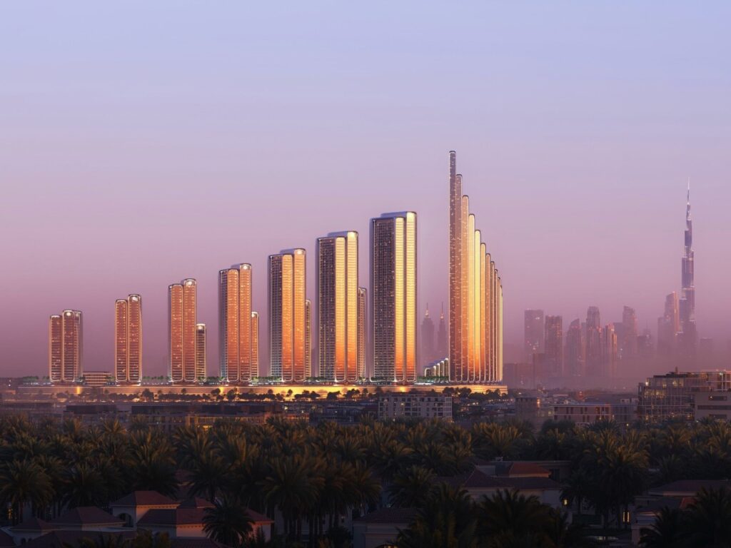 Distant skyline view of Binghatti City's 12 towers against a purple hazy sky in Dubai, reflecting the sun's glow on the glass facades.