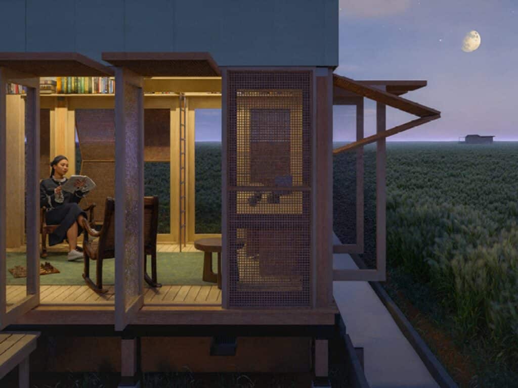 Night view of the living on groundwater house with warm interior lighting and a crescent moon in the sky.