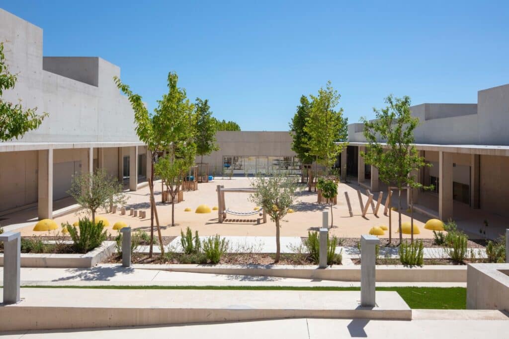 Wide view of Paul Doumer School courtyard with shaded areas and newly planted trees.