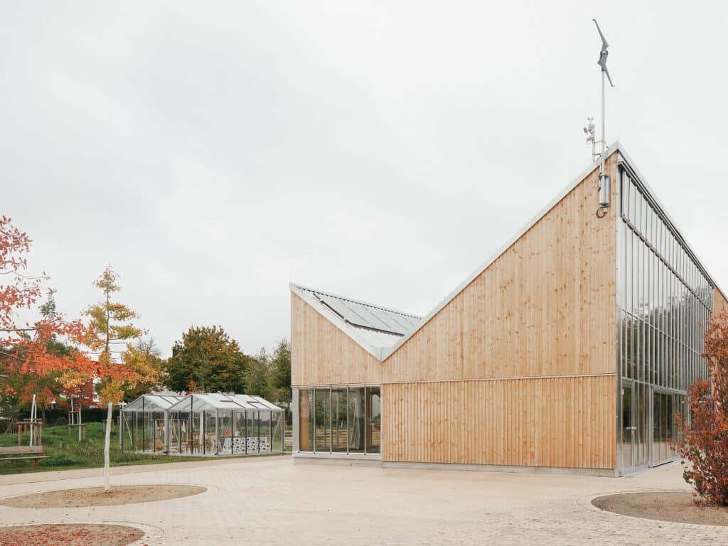 External view of the Climate Pavilion next to experimental greenhouses in the Ruhr International Garden Exhibition 2027.