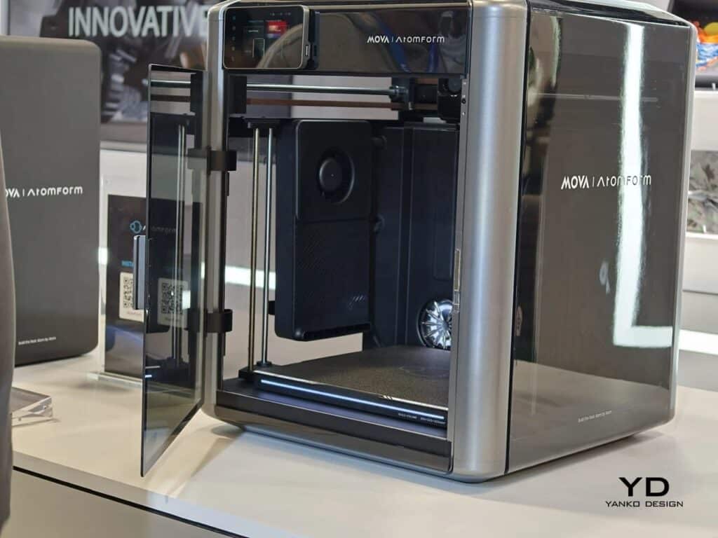 A professional AtomForm Palette 300 3D printer with an open glass door, showcasing the internal 12-nozzle OmniElement system and a 300x300x300 mm build chamber.