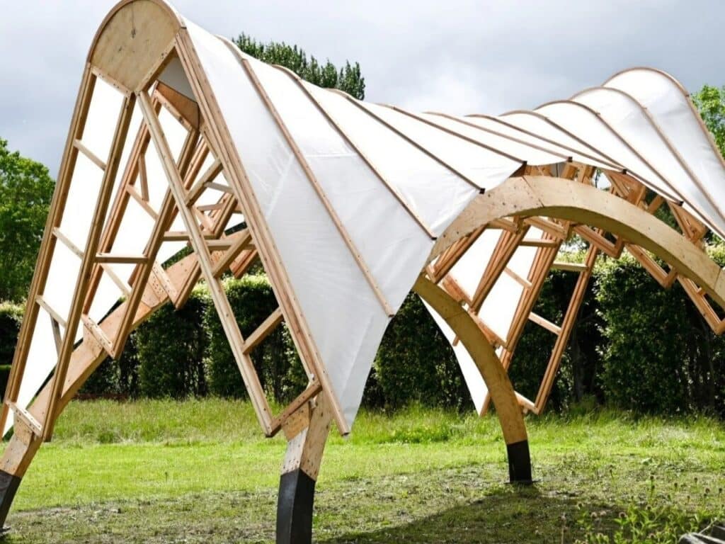 Perspective view of the Arkhive pavilion's dynamic timber roof and fabric covering, highlighting its sci-fi inspired architectural form.