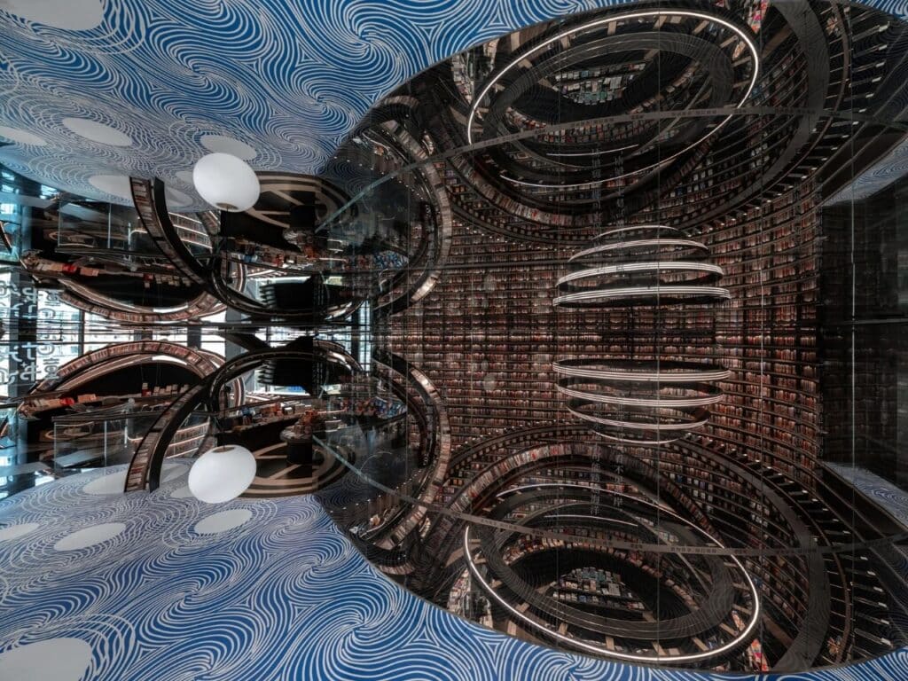 Abstract architectural view of swirling blue patterns on the ceiling and mirrored walls in Huai&rsquo;an Zhongshuge.