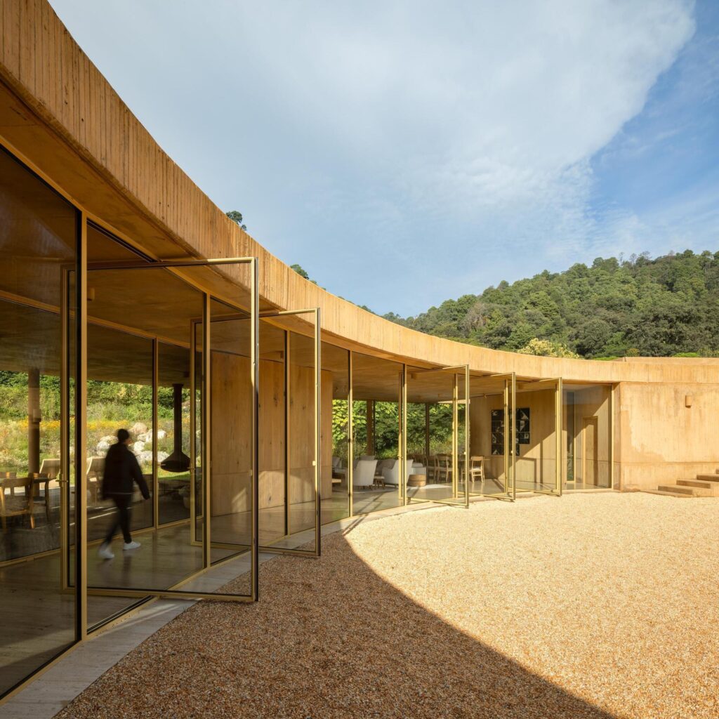 Large folding glass doors of the Degrees house opening towards the central courtyard.
