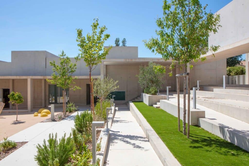 Outdoor amphitheater-style seating and greenery at Paul Doumer School.