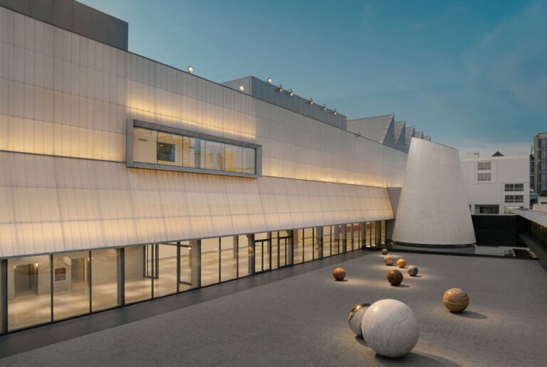 First international contemporary art museum in Bangkok exterior at dusk with sculptural spheres and illuminated facade