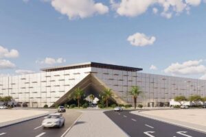 Hexagon Saudi Arabia data center facade with geometric cladding and palm trees under blue sky