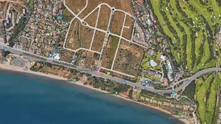 An aerial rendering of the Marbella luxury development, showcasing modern white residential buildings with private pools nestled in lush green landscaping.