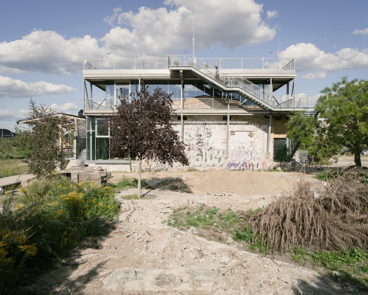 Exterior view of the ZK/U Center in Berlin, an example of architectural reuse, showing the new lightweight structure enveloping the original building.