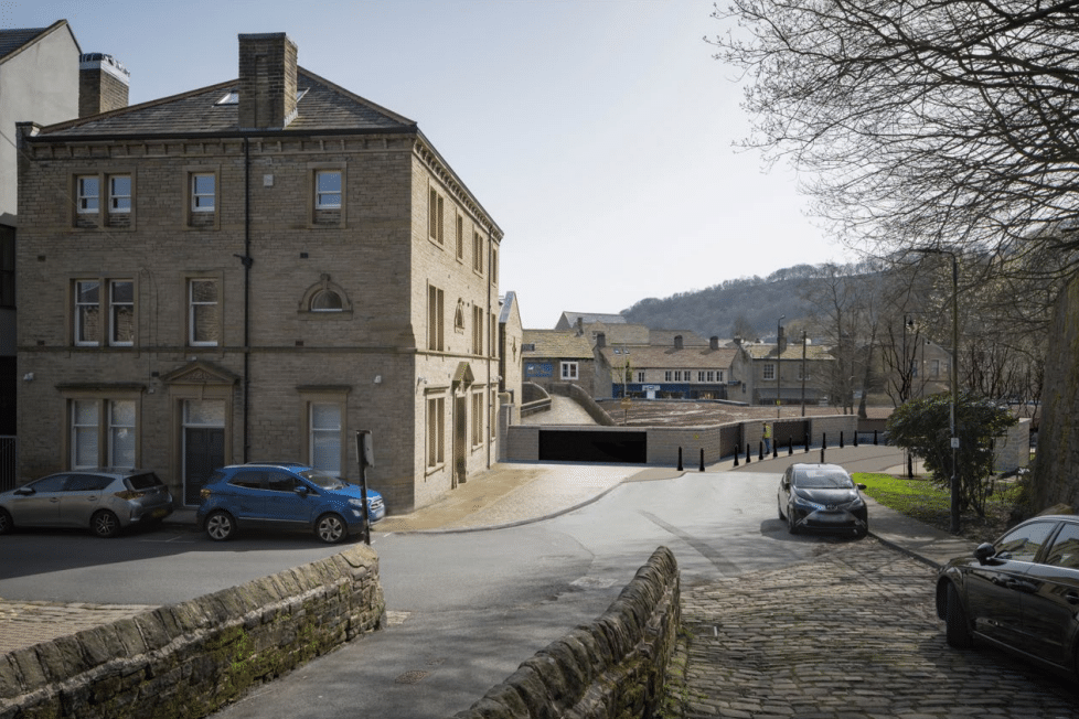Traditional stone architecture and cobblestone streetscape in the Top of Town district, illustrating the historic context for the Bradford City Village regeneration.