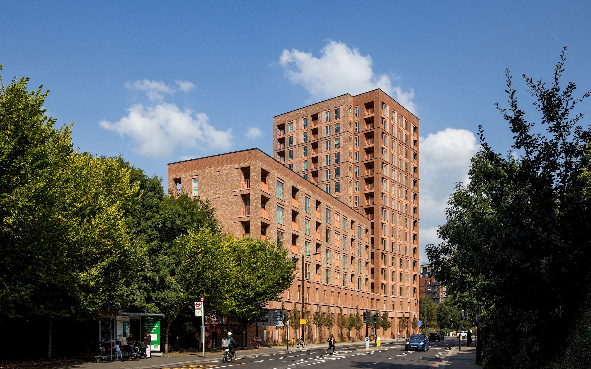 Exterior view of the new Brentford residential development featuring multi-unit brick apartment blocks against a blue sky.