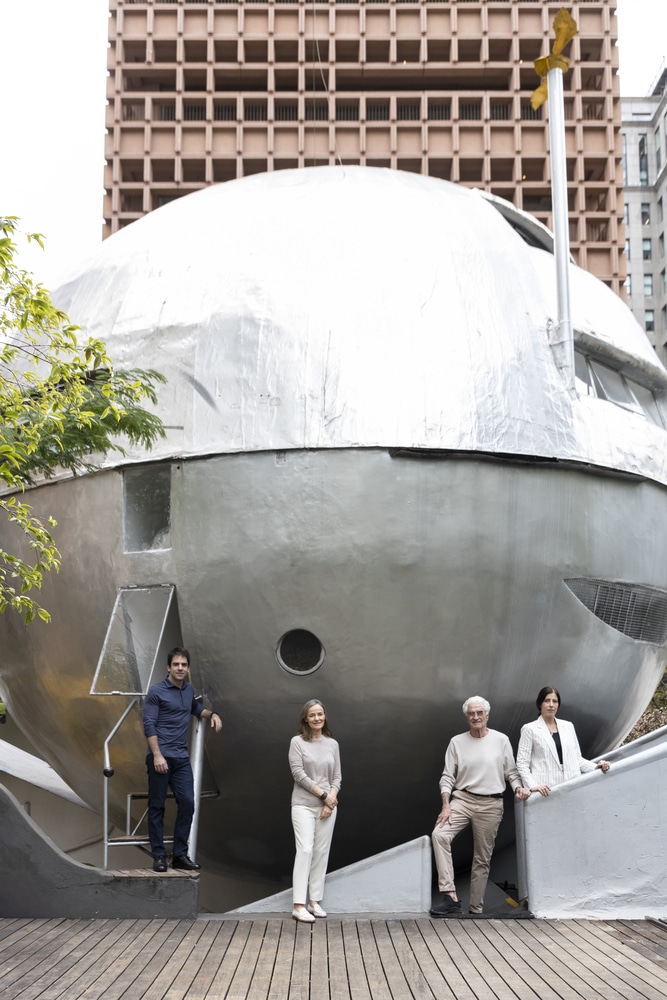 Exterior view of the Spherical House in S&atilde;o Paulo featuring architect Eduardo Longo and ABERTO5 curators standing on the deck.