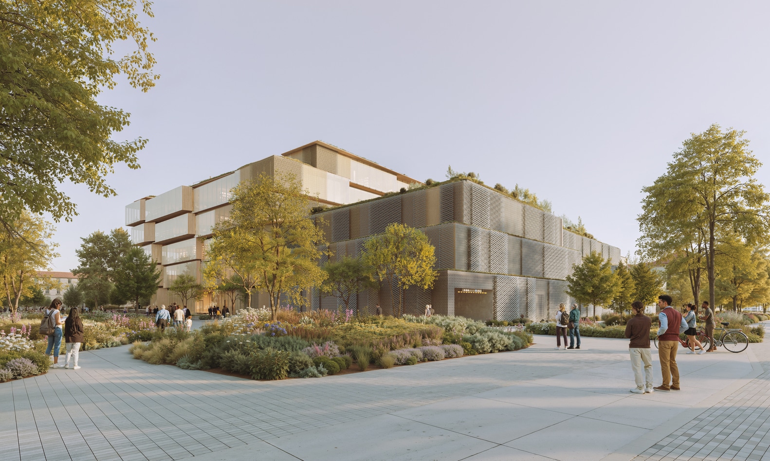 Pedestrians walking through a landscaped plaza towards the Spiral Library facade features champagne-toned metal mesh and glass.
