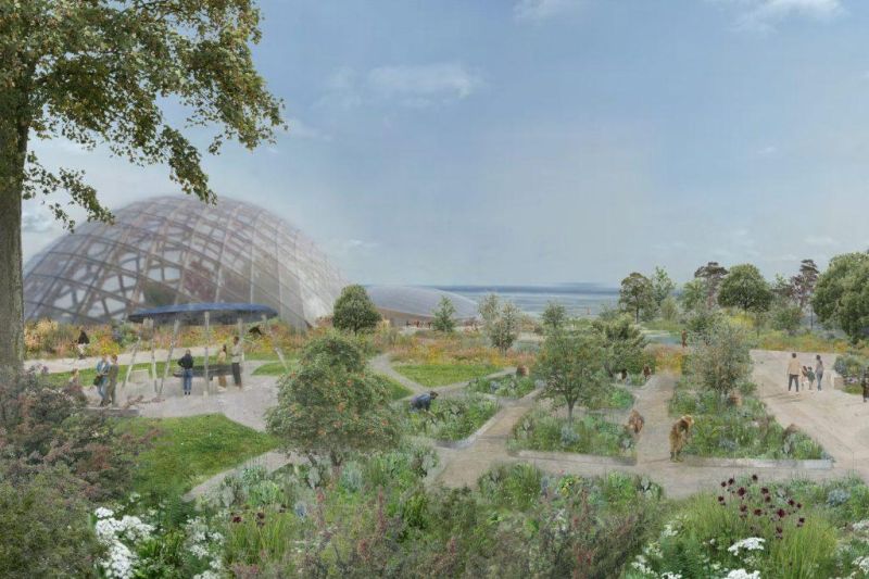 Visitors walking through diverse outdoor botanical gardens with a large transparent geodesic dome structure rising in the background.