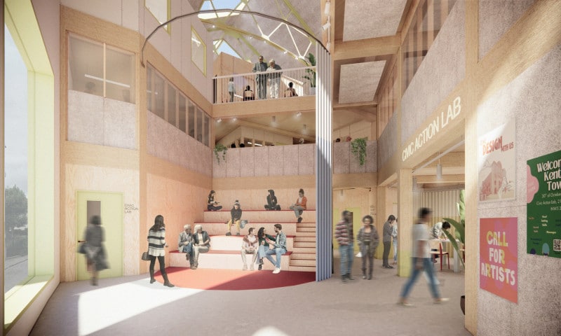 Double-height interior of the cinema retrofit featuring a "building within a building" timber structure, a central wooden tiered seating area, and skylights illuminating the Civic Action Lab.