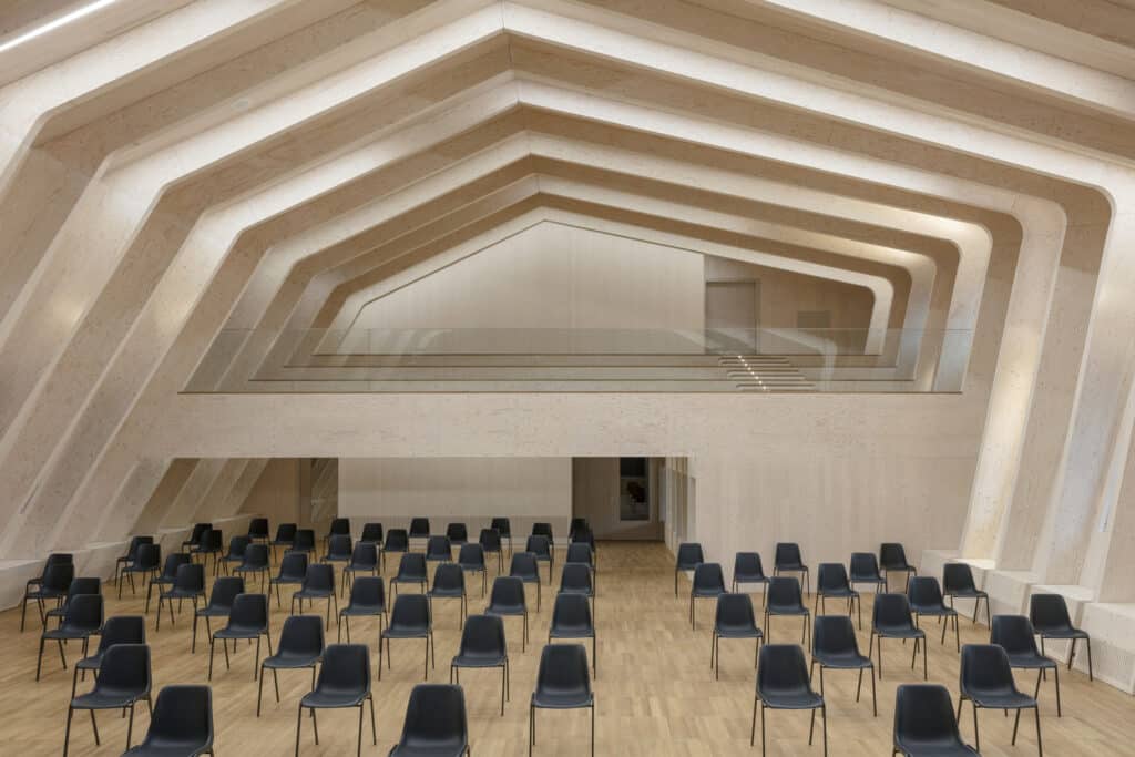 Interior view of the AI Pavilion, highlighting the exposed cross-laminated timber walls and ceiling structure, a prime example of innovative Timber Construction.