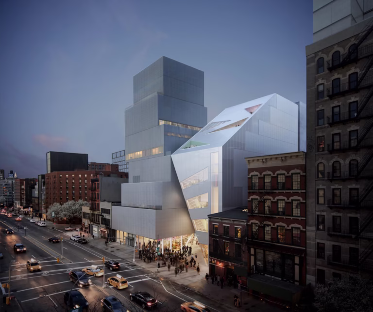 Street view of the OMA-designed New Museum expansion featuring an angular glass fa&ccedil;ade next to the existing SANAA building.